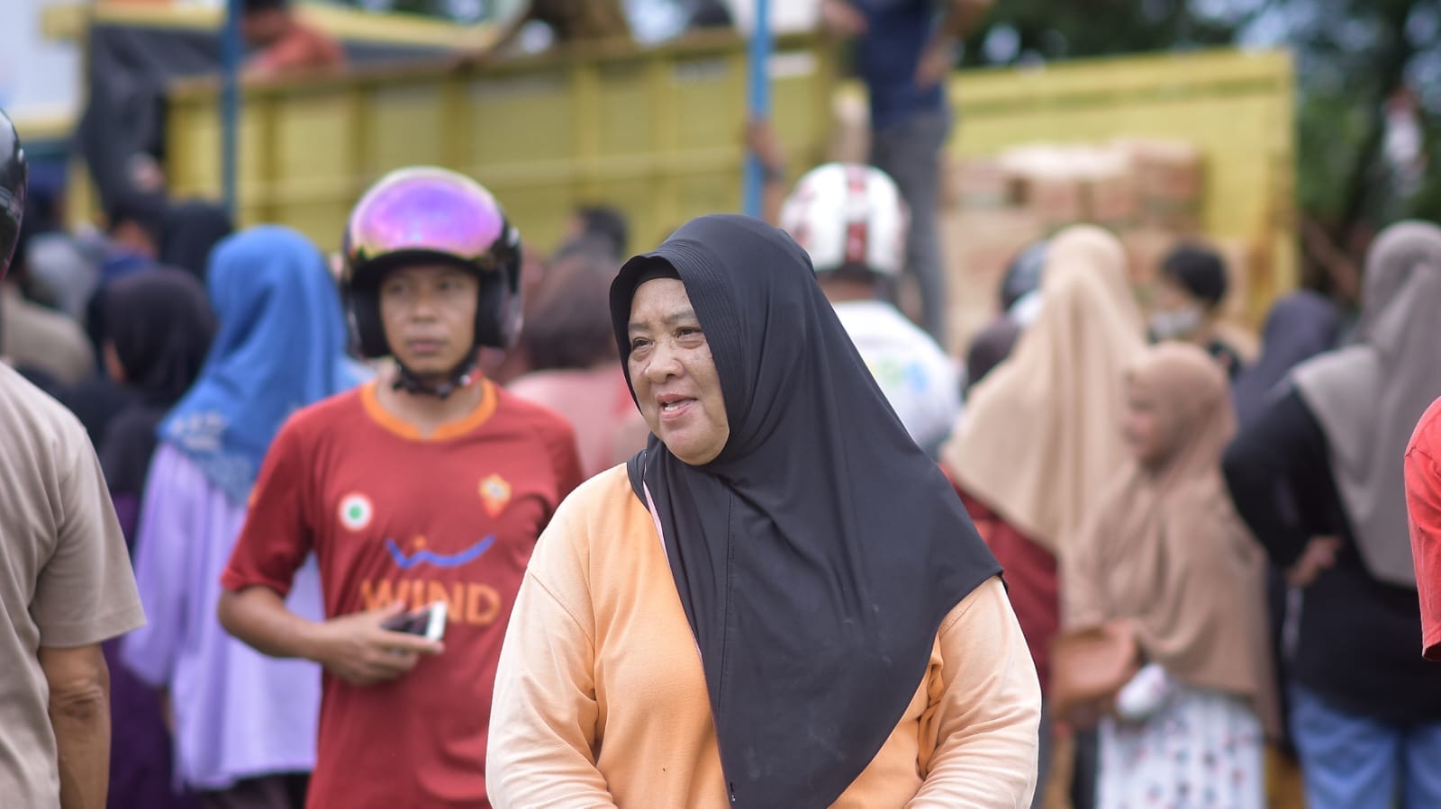 Seorang emak-emak dengan ekspresi bahagia usai mendapatkan sejumlah bahan pokok murah dalam operasi pasar, di Lapangan Gelora, Kecamatan Mentok, Kabupaten Bangka Barat, pada Kamis (22/02/2024) pagi.